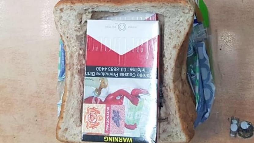 Motorcyclist tries to smuggle cigarettes hidden in loaf of bread into Singapore Motorcyclist tries to smuggle cigarettes hidden in loaf of bread into Singapore