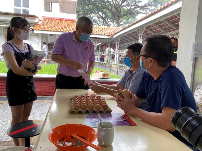 Mr Goh Meng Seng speaking to residents during his walkabout at MacPherson Market and Food Centre on Saturday (June 27).