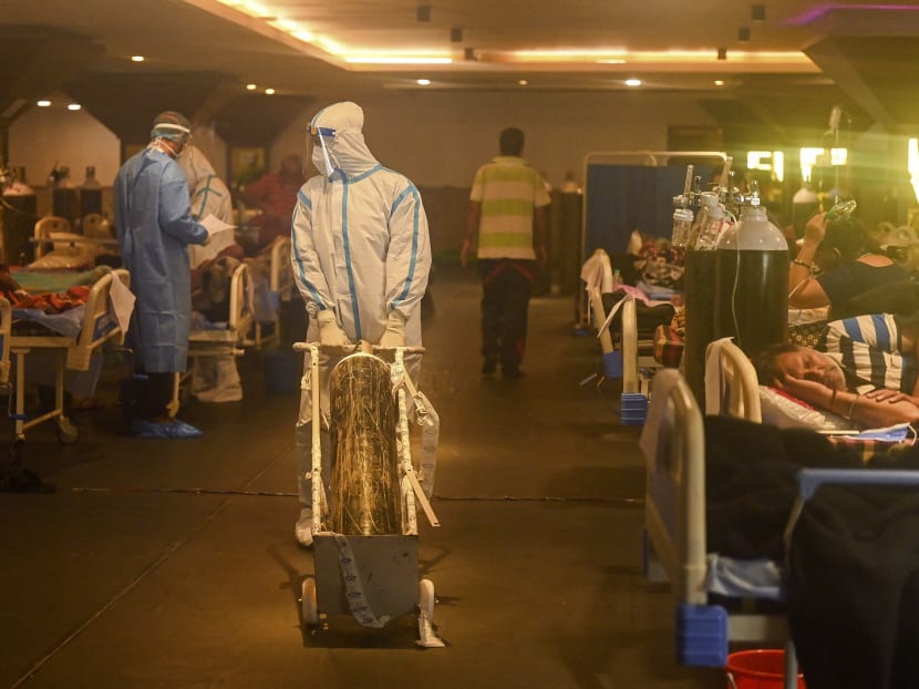 Health workers wearing personal protective equipment attend to Covid-19 patients inside a banquet hall temporarily converted into a coronavirus care centre in New Delhi, Inda on April 28, 2021.