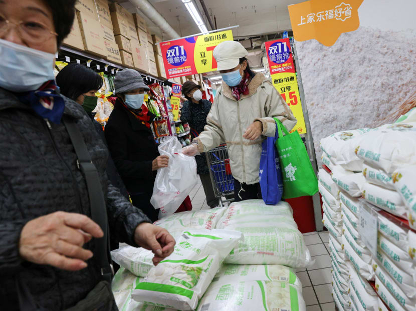 People buy bags of rice at a supermarket following outbreak of Covid-19 in Beijing, China on Nov 3, 2021. People buy bags of rice at a supermarket following outbreak of Covid-19 in Beijing, China on Nov 3, 2021.