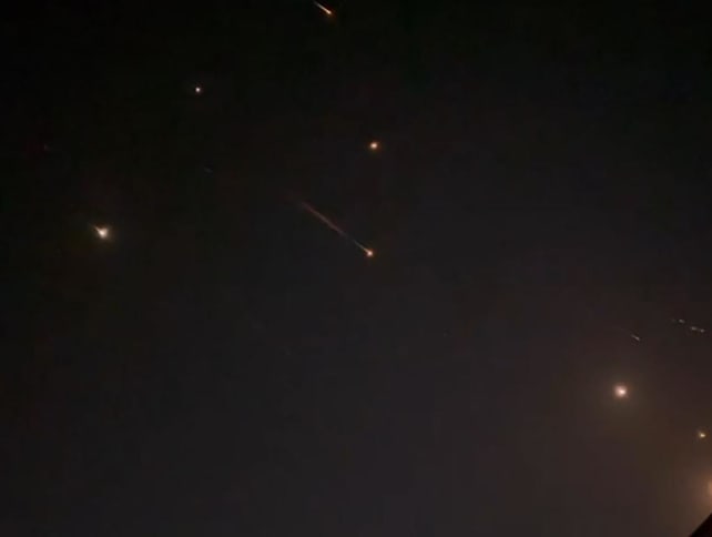 This video grab from AFPTV taken on April 14, 2024 shows explosions lighting up the sky in Hebron in the Israeli-occupied West Bank during an Iranian attack on Israel. 