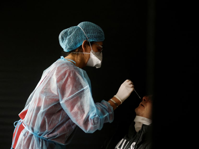 A medical worker, wearing a protective suit and a face mask, performs a rapid Covid-19 antigenic test on a patient in a Covid-19 testing centre in Sautron near Nantes, France on Dec 7, 2020. A medical worker, wearing a protective suit and a face mask, performs a rapid Covid-19 antigenic test on a patient in a Covid-19 testing centre in Sautron near Nantes, France on Dec 7, 2020.