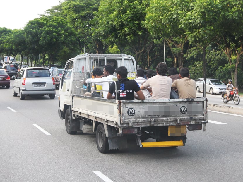 A file photo of migrant workers being transported in the back of a lorry in 2010.