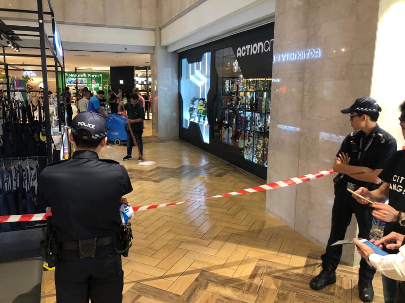 Police on the scene outside an Action City store at the Basement 2 level of the Orchard Road mall.