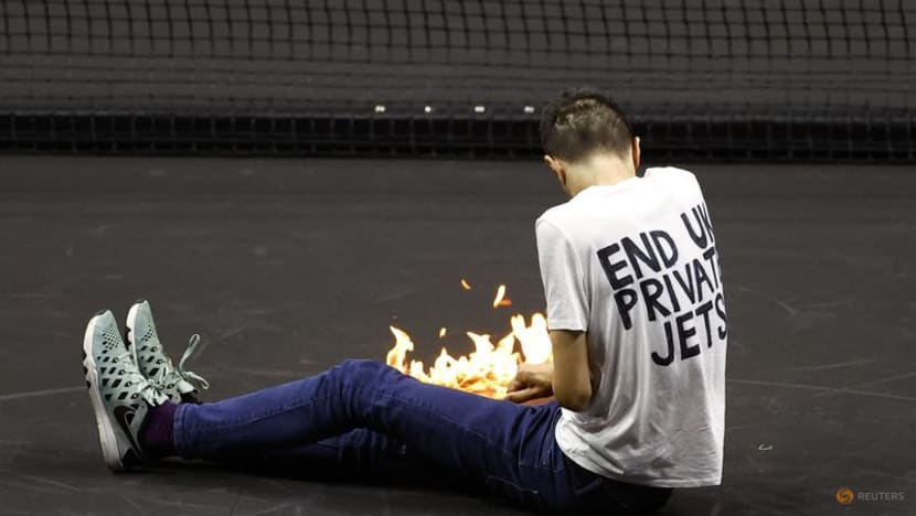 Laver Cup match briefly halted after protester sets arm on fire on court Laver Cup match briefly halted after protester sets arm on fire on court