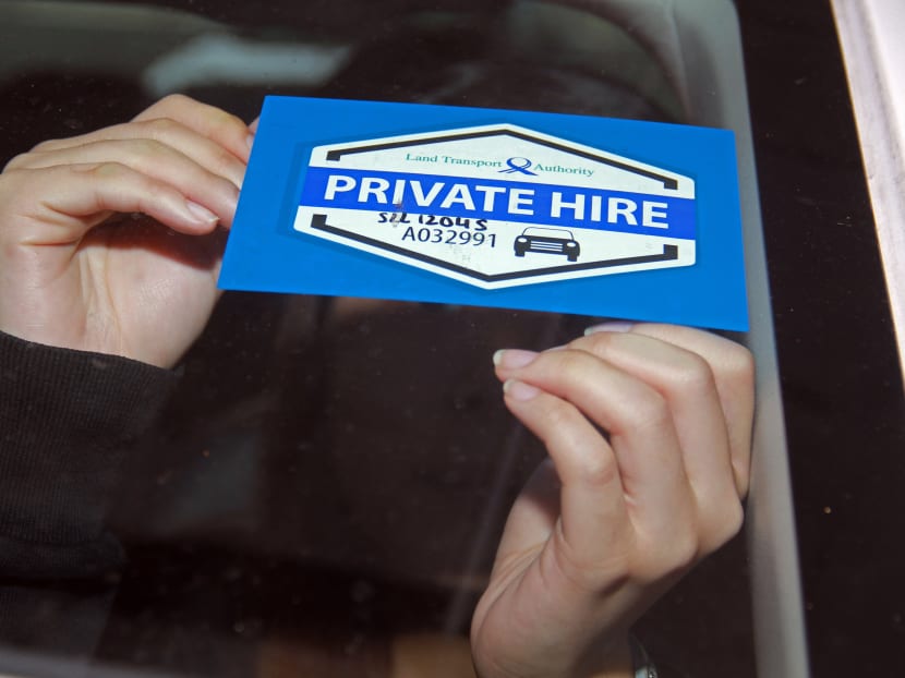 From July 1, 2017, all private hire cars that provide chauffeured services must display a pair of tamper-evident decals on the front and back windscreen of their vehicles. A decal seen being affixed on a vehicle on June 23, 2017.  Photo: Esther Leong/TODAY