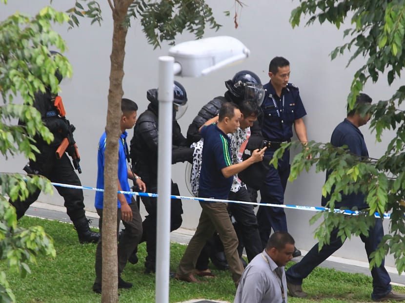 Authorities escort a suspect in a hostage case on Sembawang Drive on Sept 27, 2016. Photo: Koh Mui Fong/TODAY