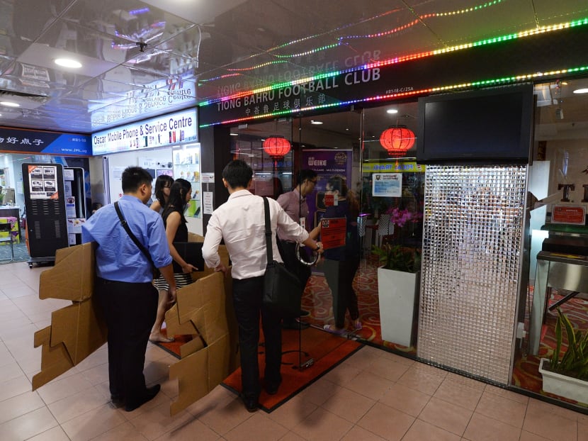 Investigators arriving with carton boxes at Tiong Bahru Football Club clubhouse at People's Park Centre on April 20, 2017. Investigators arriving with carton boxes at Tiong Bahru Football Club clubhouse at People's Park Centre on April 20, 2017.