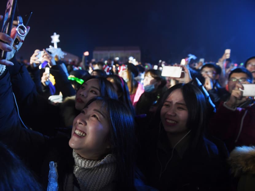 Chinese women pose for a selfie during New Year celebrations in Beijing on Dec 31, 2016. AFP file photo