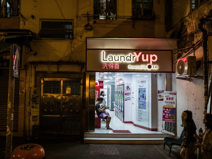 A LaundrYup in the Hung Hom neighbourhood of Hong Kong. As prices keep soaring in what is already the world’s most expensive property market, residents of Hong Kong have been forced to squeeze into ever smaller apartments, leaving little room for washers and dryers. Photo: The New York Times