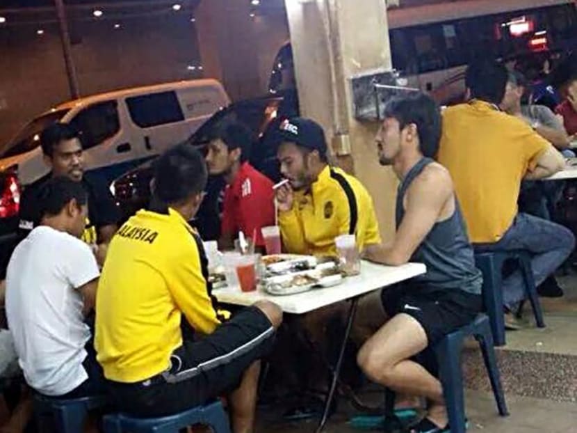 This picture allegedly shows Malaysian national team footballers smoking while having supper at an eating establishment near their team hotel in Singapore. Photo: Facebook/Jose Raymond