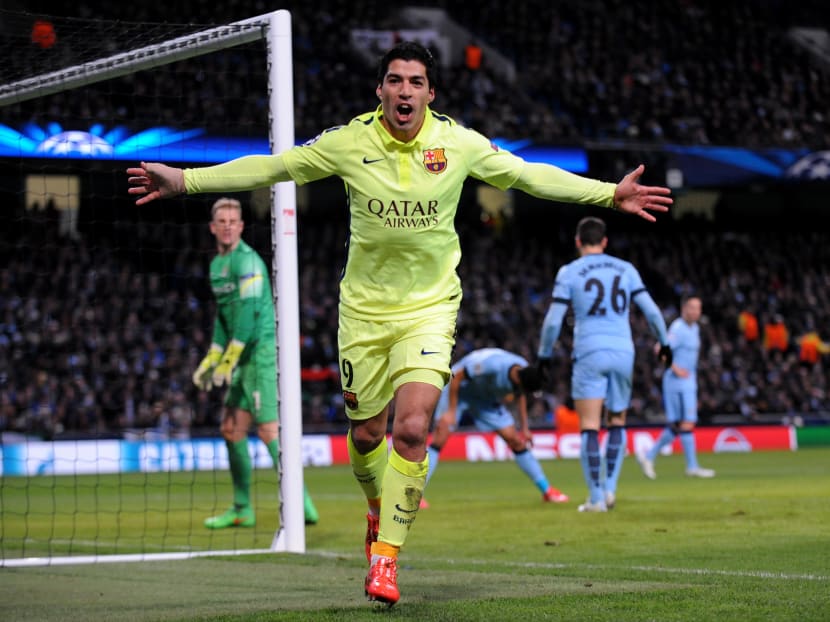 Barcelona's Luis Suarez celebrates after scoring his second goal against Manchester City during the Champions League round 16 match between Manchester City and Barcelona at the Etihad Stadium, in Manchester, England. Photo: AP
