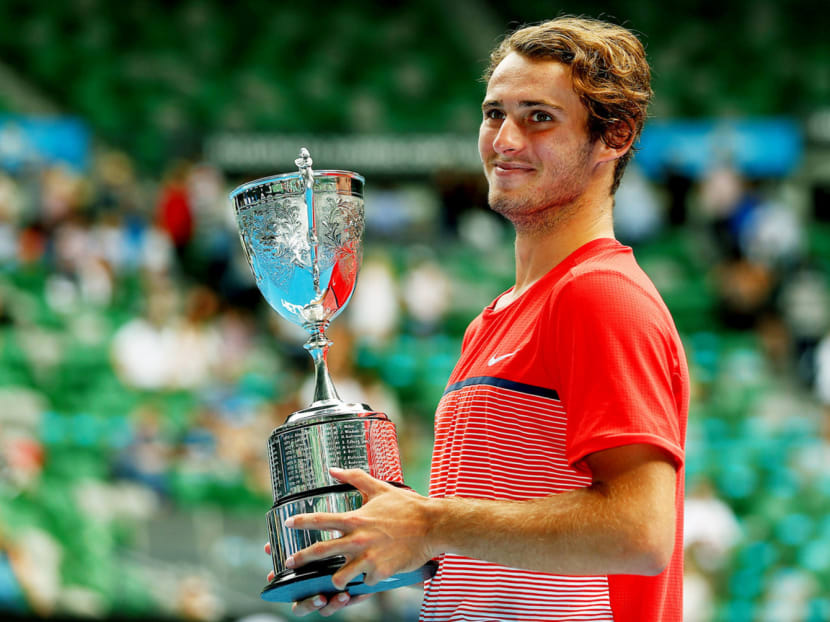Australia’s Oliver Anderson posing with his trophy after winning the Junior Boys’ singles final at the Australian Open in January last year. Police said he had been charged with match-fixing at a tournament in Victoria last October, and will appear in court in March. Photo: REUTERS