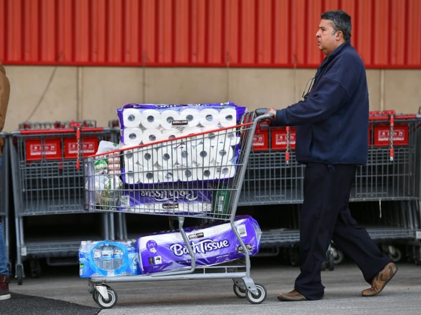 A man leaves a supermarket with a trolley full of toilet paper and cleaning products as fears of a second wave of Covid-19 sparked a rush on some items in Melbourne on June 24, 2020.