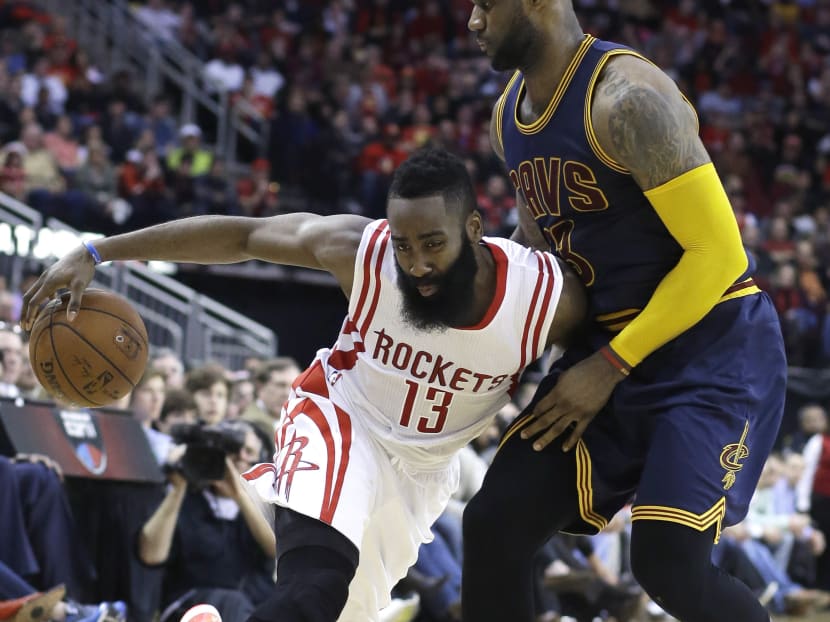 Houston Rockets' James Harden (13) pushes against Cleveland Cavaliers' LeBron James (23) in the second half of an NBA basketball game on March 1 in Houston. The Rockets won 105-103 in overtime. Photo: AP