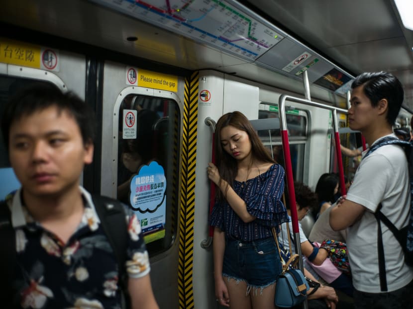 Commuters on an underground MTR train in Hong Kong on July 18, 2016. Photo: AFP