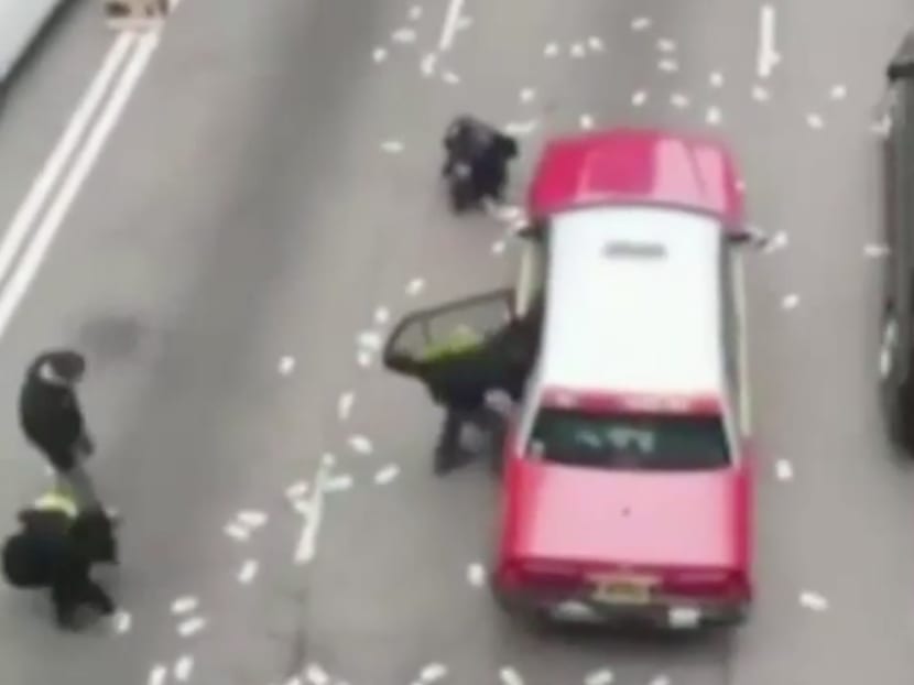 Screengrab of YouTube video showing passers-by picking money up on the road after van spills money. Photo: SCMP/YouTube