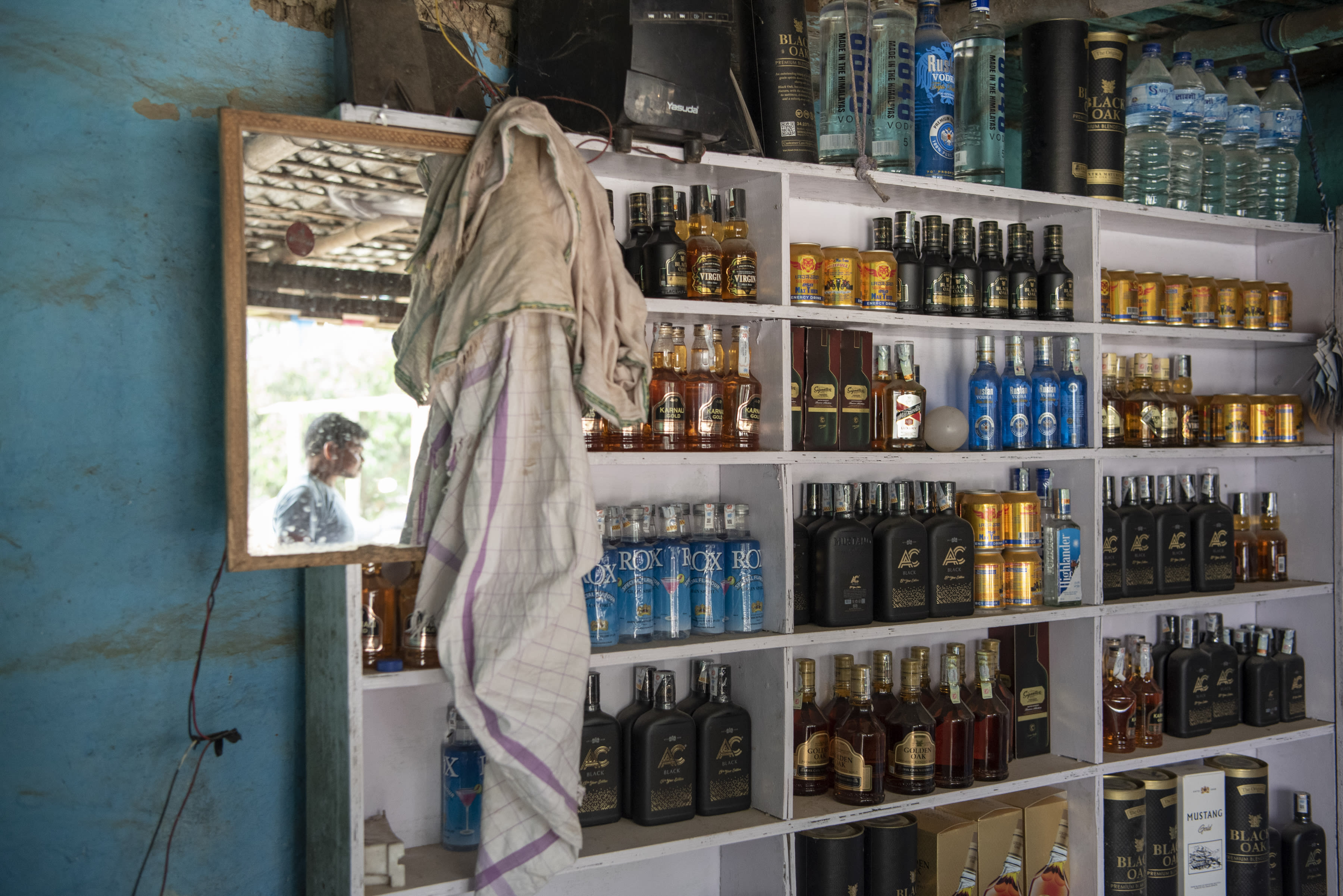 A shop selling bottles of Nepali alcohol, with labels that often copy designs from well-known international brands, near Maruwai, Nepal on April 15, 2022. Since the Indian state of Bihar banned alcohol in 2016, a small industry of bars and restaurants has sprung up just across the border in Nepal, catering to Indians of all classes seeking to quench their thirst. 
