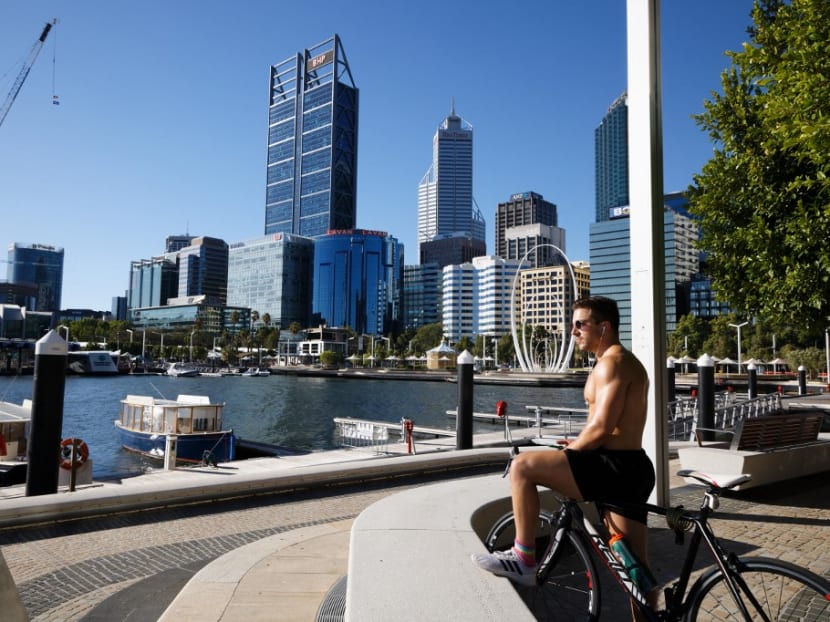 A cyclist looks out over the normally busy Elizabeth Quay area in Perth on January 31, 2021, as authorities announced a snap Covid-19 lockdown.
