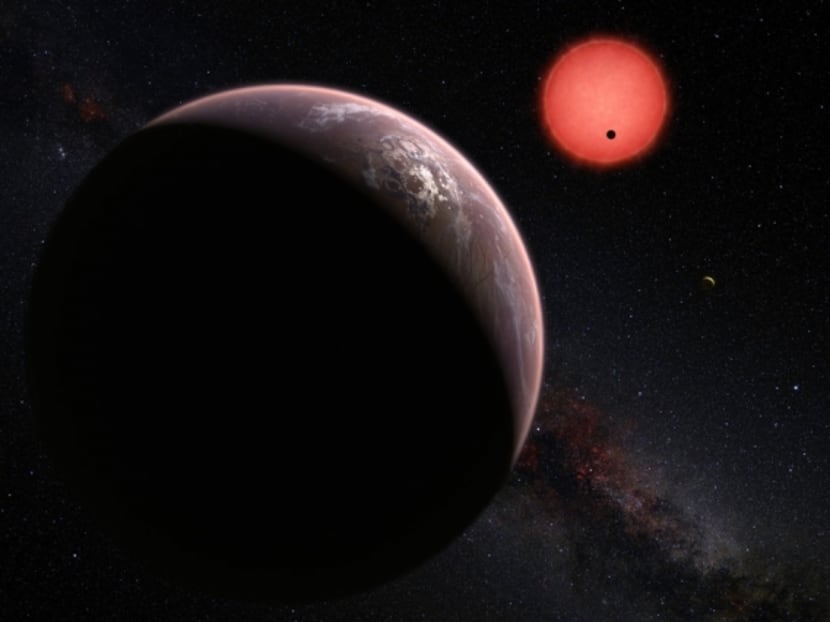 This artist’s rendering shows an imagined view of the three planets orbiting an ultracool dwarf star just 40 light-years from Earth that were discovered using the TRAPPIST telescope at ESO’s La Silla Observatory. In this view, one of the inner planets is seen in transit across the disc of its tiny and dim parent star. Image: ESO