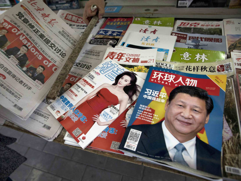 A magazine featuring Chinese President Xi Jinping with the headline "China becomes strong" is placed next to a magazine with popular Chinese actress Fan Bingbing at a news stand in Beijing, China. Photo: AP