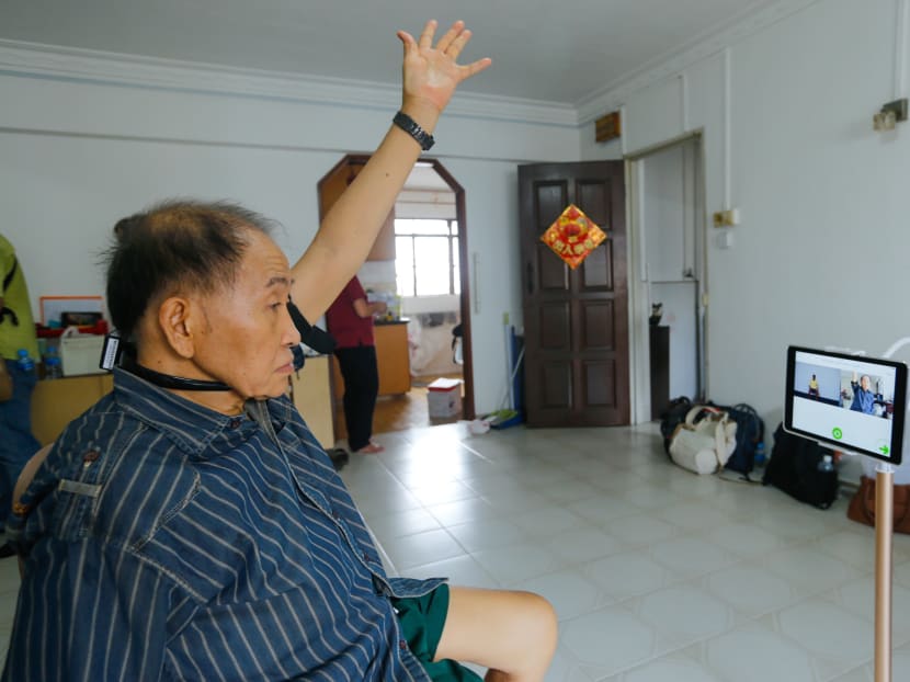 Chin Tian Loke, 72, a client of TOUCH Home Care using the Smart Health Telerehab system in his house. The model in the program will guide him through the various exercises and a therapist from the Home will monitor his progression. Photo: Najeer Yusof/TODAY