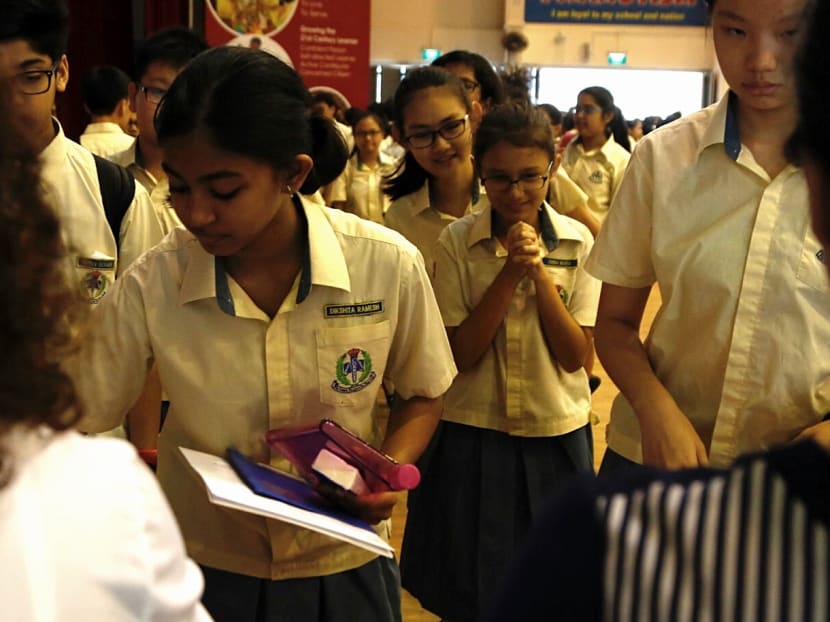 Students receiving their PSLE results in 2017. The author says the revamp of the PSLE scoring system could lead to concerns among some parents about increased competition for entry into the prestigious secondary schools.