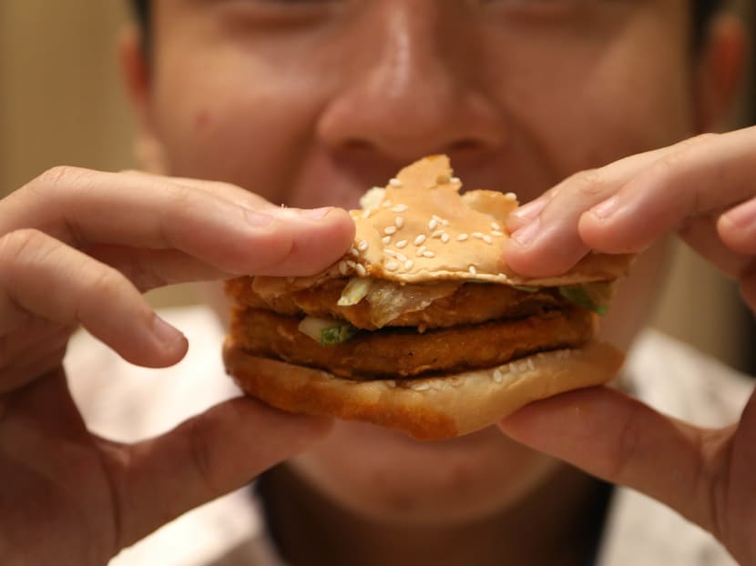 Close-up of a burger being eaten.