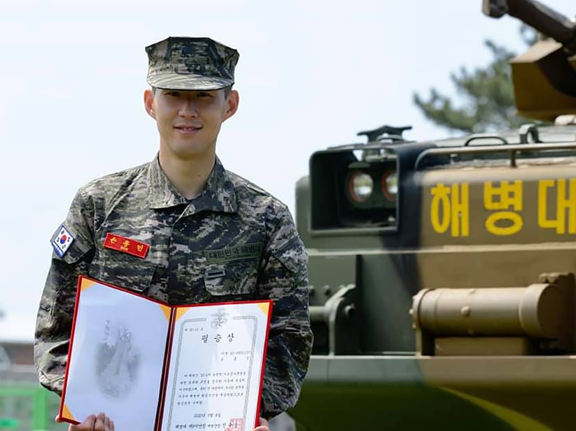 Tottenham Hotspur's South Korean striker Son Heung-min poses in military uniform with a prize during a basic military training completion ceremony at a marines boot camp in Jeju island.
