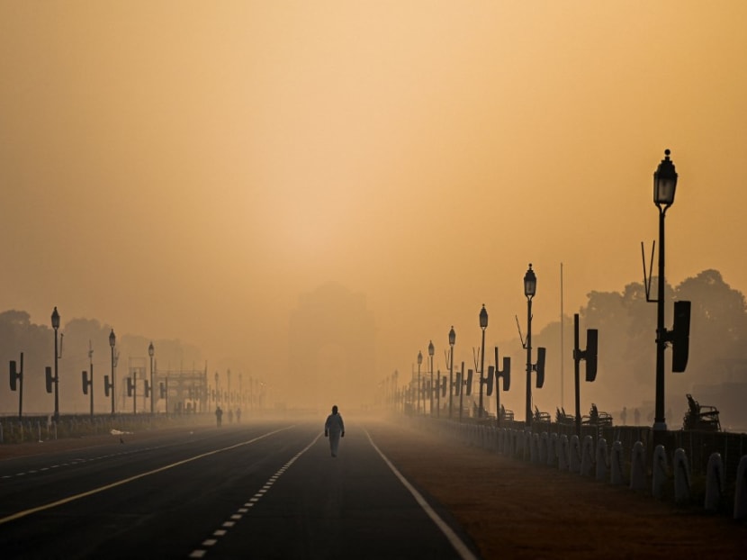 A man walks along Rajpath amid smoggy conditions in New Delhi on Jan 28, 2021.