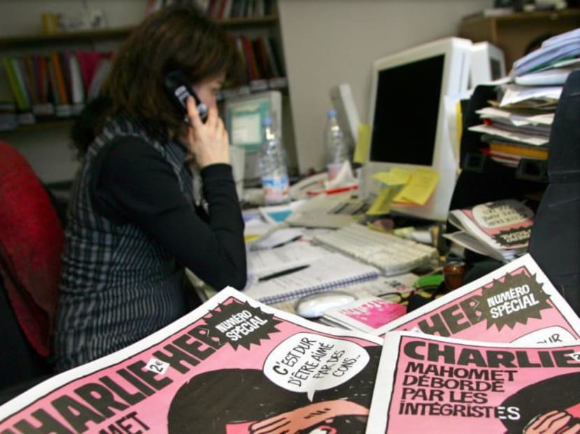 A journalist works in the Paris newsroom of French satirical weekly Charlie Hebdo. Photo: Reuters