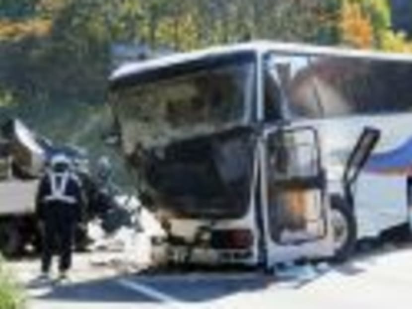 A tour bus, wrecked after a head-on collision with a truck, is seen on a street in Nanae town on the northern Japanese island of Hokkaido, Oct 23, 2014. Photo: Reuters/Kyodo