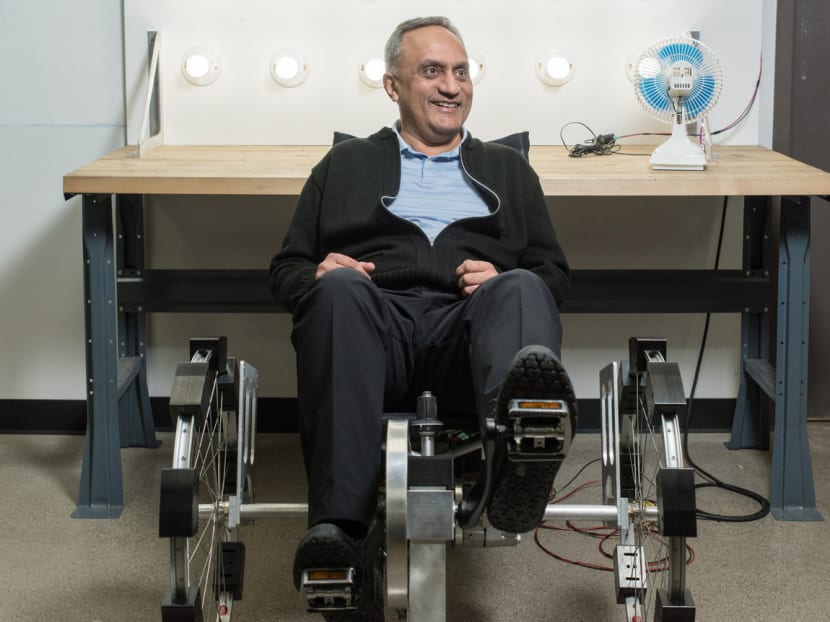 Mr Manoj Bhargava on the electricity-generating bicycle. Source: Billions in Change via Bloomberg