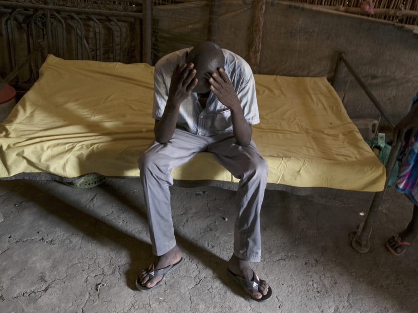 Duop, a former child soldier who is around 16 years old, sits on a cot in his aunt's shack at a displaced persons camp in Bentiu, South Sudan, which is near his home village, on Feb 10, 2017. Photo: The New York Times