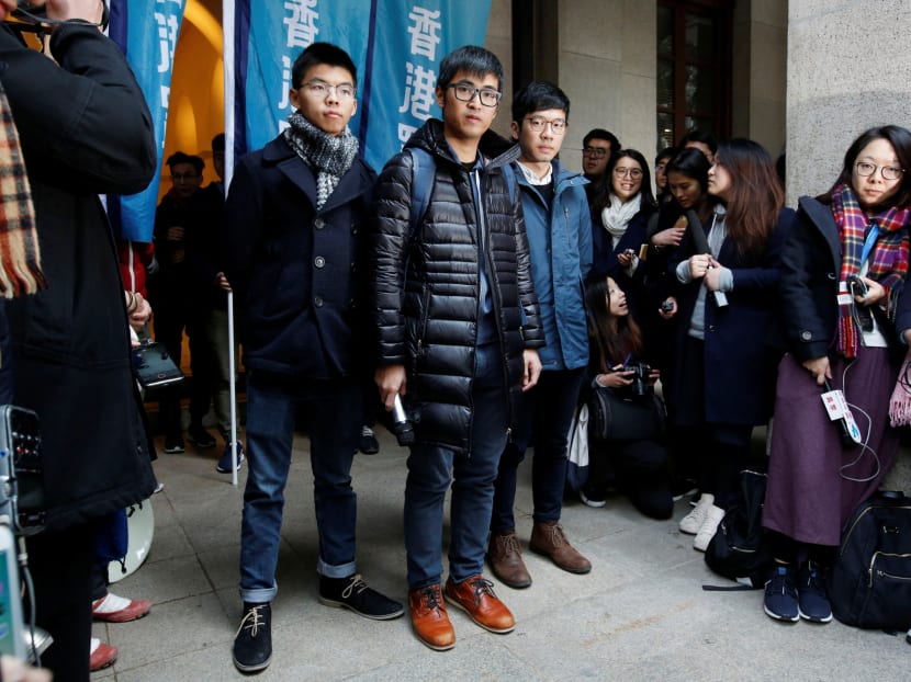 Pro-democracy activists (L-R) Joshua Wong, Alex Chow and Nathan Law pose outside the Court of Final Appeal. Legal experts say a judgment delivered by Hong Kong’s top court as it set the trio free could have a “chilling effect” on future protests. Photo: Reuters