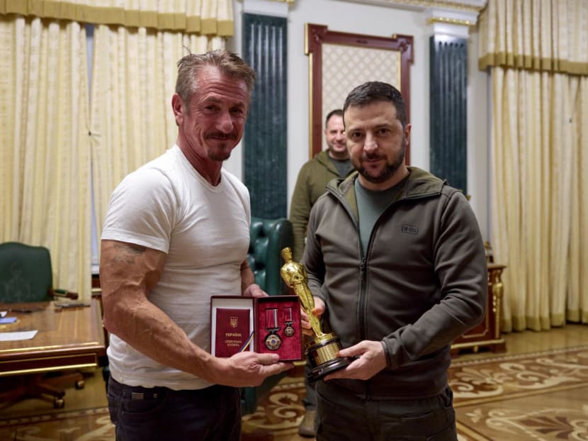 Handout picture by Ukraine's presidential press-service on Nov 8, 2022 shows Mr Volodymyr Zelensky (right) posing with United States actor Sean Penn (left) after receiving latter's Oscar statuette and handing him the Order of Merit, III degree during their meeting in Kyiv. Handout picture by Ukraine's presidential press-service on Nov 8, 2022 shows Mr Volodymyr Zelensky (right) posing with United States actor Sean Penn (left) after receiving latter's Oscar statuette and handing him the Order of Merit, III degree during their meeting in Kyiv.