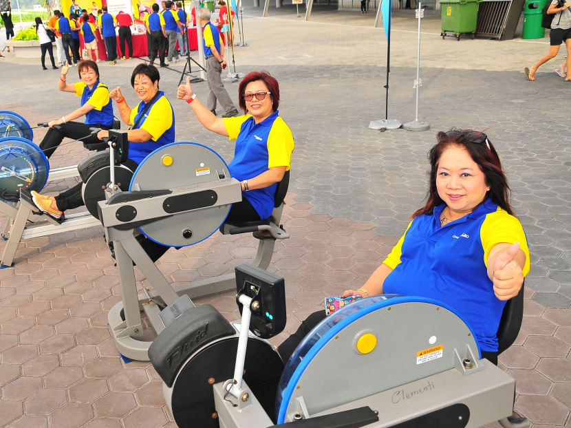 ComfortDelGro taxi drivers trying out rowing machines at the launch event for the ComfortDelGro-ActiveSG collaboration this morning. Some 500 taxi drivers and their family members were at the event today. Photo: Sport Singapore