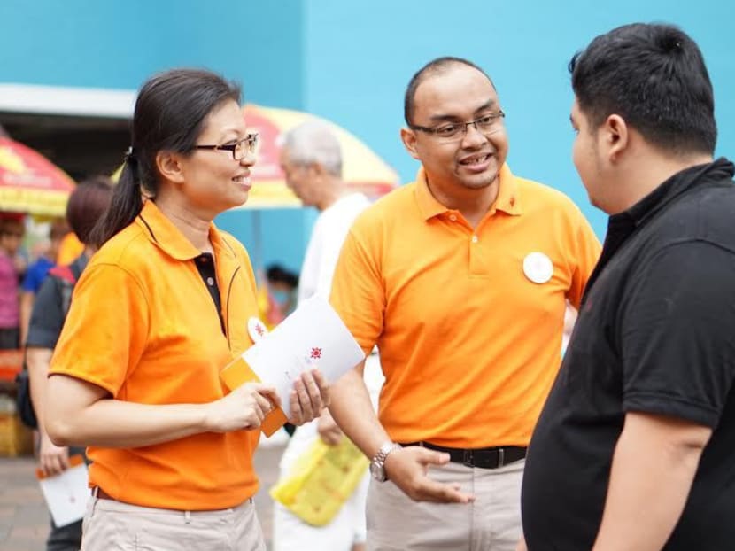 National Solidarity Party’s Central Executive Committee member Mohamed Fazli Talip (right, in an orange T-shirt) has resigned from the party. He is pictured here with NSP's former acting secretary general, Ms Hazel Poa. TODAY file photo