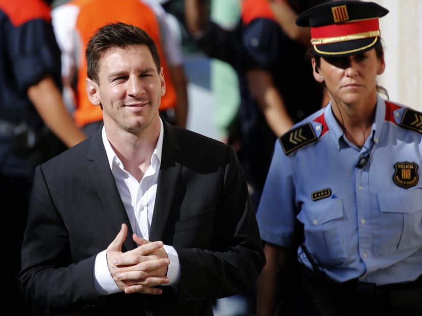 In this file photo, Barcelona FC star Lionel Messi (left) arrives at a court to answer questions in a tax fraud case in Gava, near Barcelona, Spain. Photo: AP