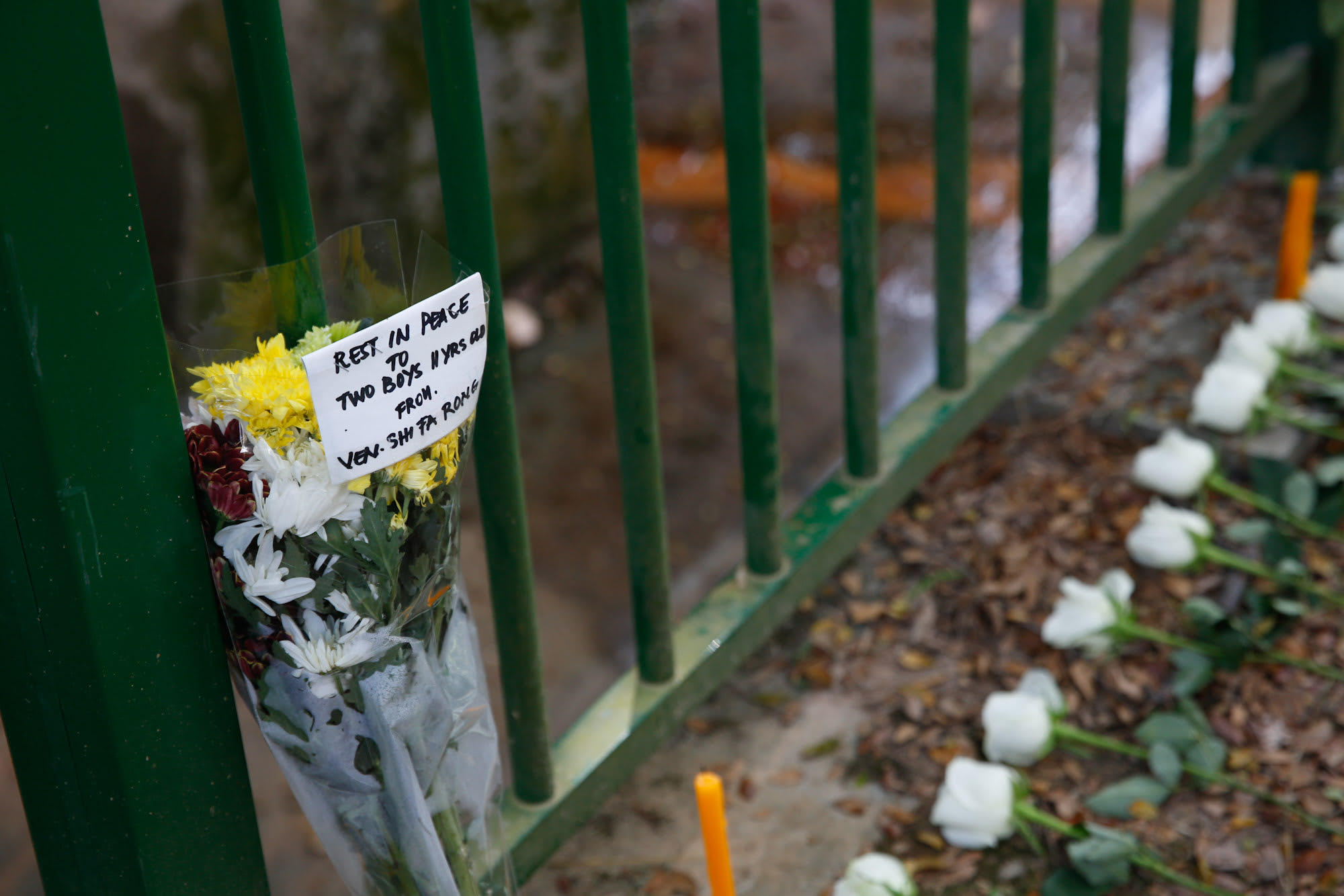 A handwritten note seen on on Jan 23, 2022, next to offerings of flowers and food at the site where the bodies of two 11-year-old boys were discovered in Upper Bukit Timah.
