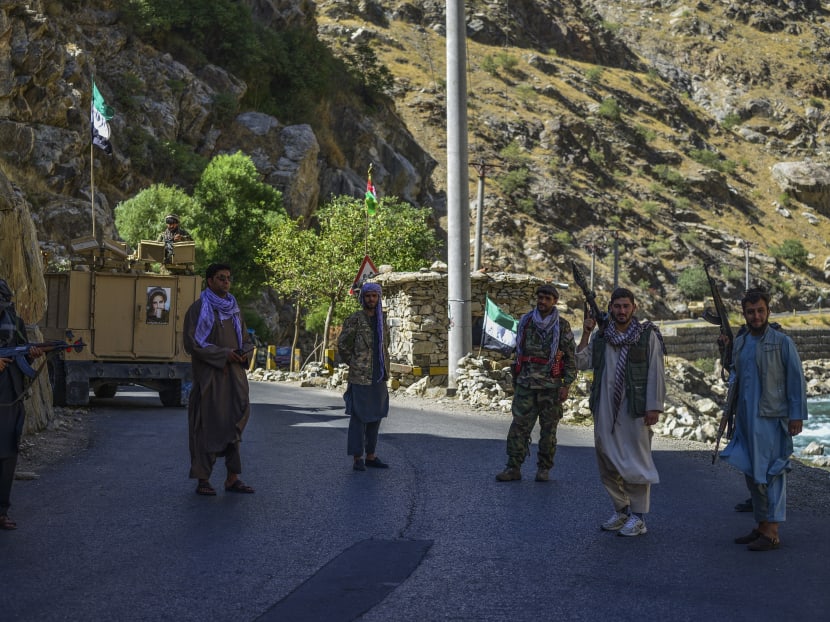 Afghan resistance movement and anti-Taliban uprising forces patrol along a road at the Rah-e Tang in Panjshir province on August 25, 2021 following Taliban's military takeover of Afghanistan.