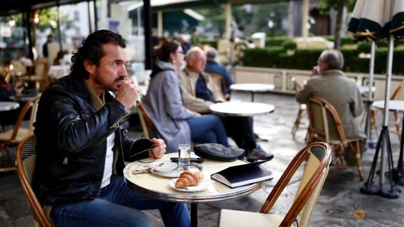 Parisians tuck into coffee and croissants again as cafes re-open Parisians tuck into coffee and croissants again as cafes re-open