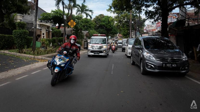 In traffic-choked Jakarta, volunteer motorcyclists help ambulances weave through congestion