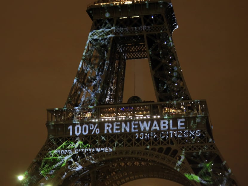 An artwork entitled 'One Heart One Tree' by artist Naziha Mestaoui is displayed on the Eiffel tower ahead of the 2015 Paris Climate Conference, in Paris, on Nov 29, 2015. Photo: AP