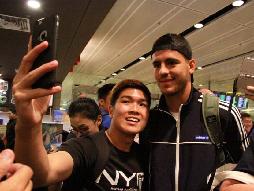 Alvaro Morata obliging a fan's request for a photo shortly after touching down in Singapore. The Spanish striker has just signed for English champions Chelsea on Friday. Photos: Esther Leong/TODAY