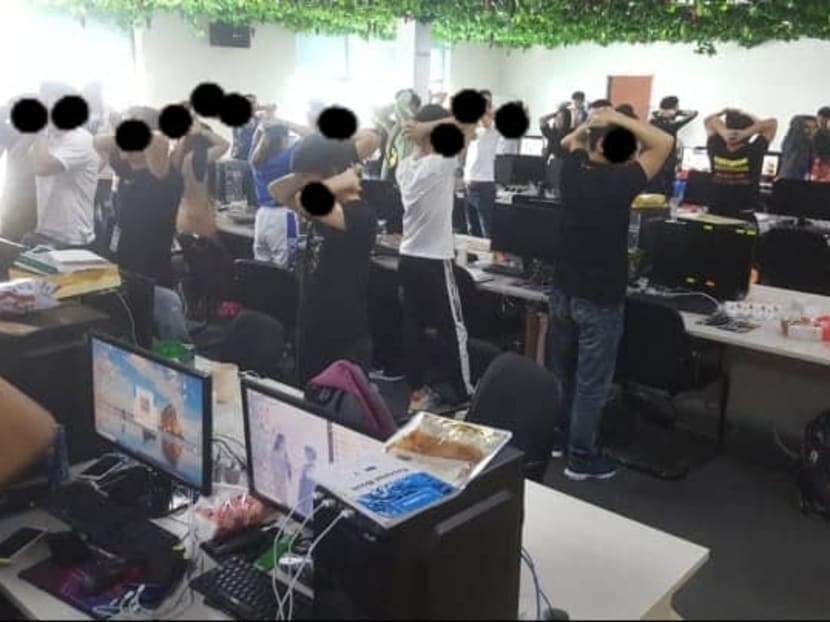 Pictures posted by Malaysia's Immigration Department on Facebook showed a group of more than 20 people standing with their arms behind their head.