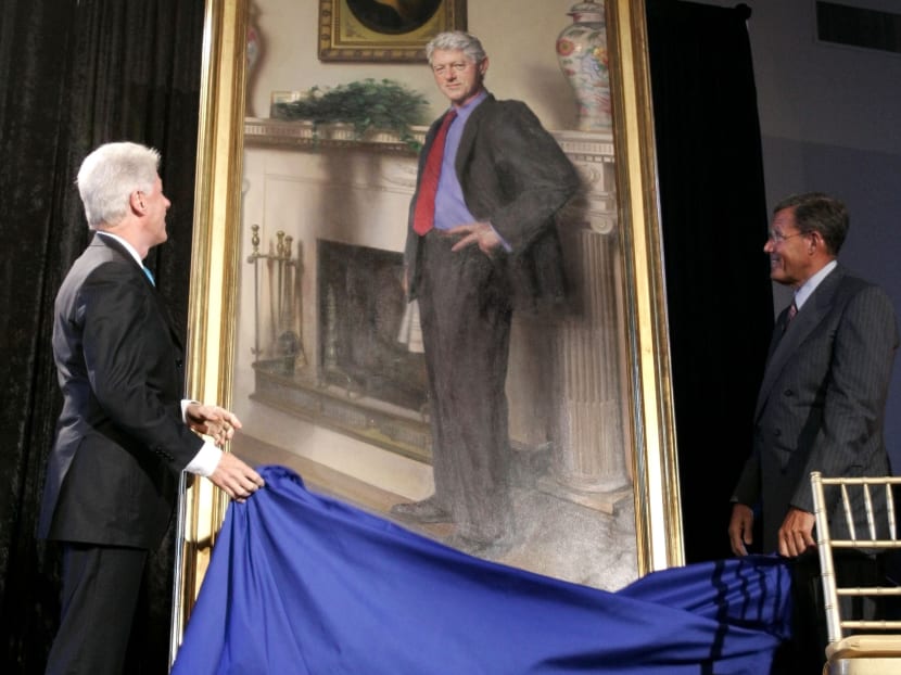 This April, 24, 2006, file photo shows former President Bill Clinton, left, looking up at his portrait after Lawrence M. Small, secretary of the Smithsonian Institution, right, helped him remove the drape at the Smithsonian Castle Building in Washington. Photo: AP