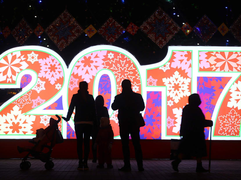 People are seen in front of big numbers reading 2017 at Oktyabrskaya Square for the upcoming New Year and Christmas season in Minsk, Belarus Dec 21, 2016. Photo: Reuters