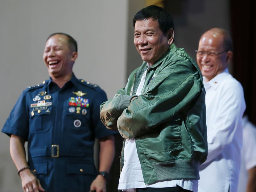 Philippine President Rodrigo Duterte wears a pilot's jacket which was presented to him during his "Talk with the Airmen" on the anniversary of the 250th Presidential Airlift Wing Tuesday, Sept. 13, 2016 at the Philippine Air Force headquarters in suburban Pasay city, southeast of Manila, Philippines. Photo: AP