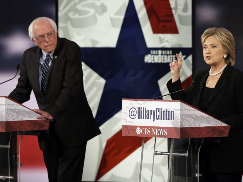 Hillary Rodham Clinton, right, makes a point as Bernie Sanders listens during a Democratic presidential primary debate in Des Moines, Iowa. Photo: AP